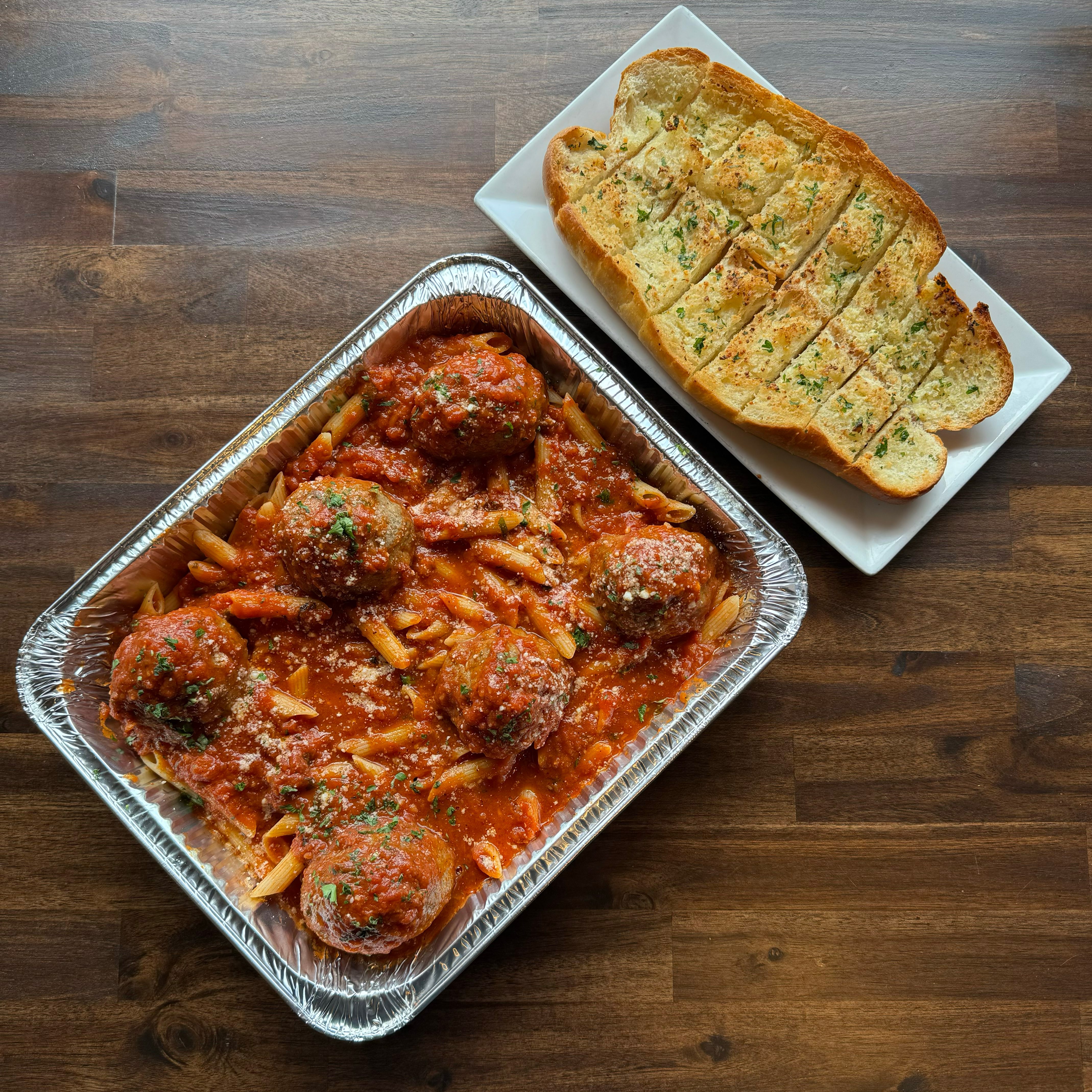 1/2 Tray Pasta with Meatballs & Garlic Bread.